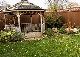 6 foot tall mocha walnut vinyl fence