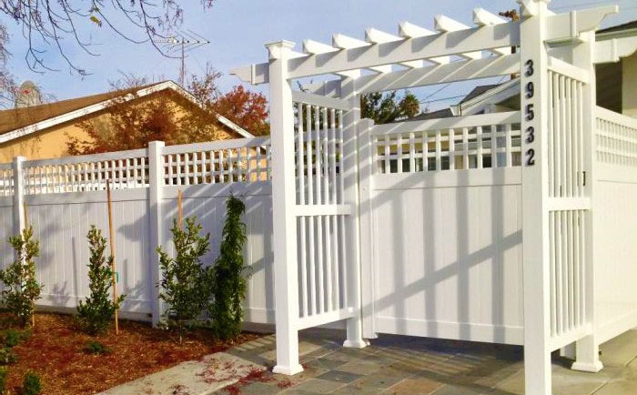 White vinyl fence with straight top arbor