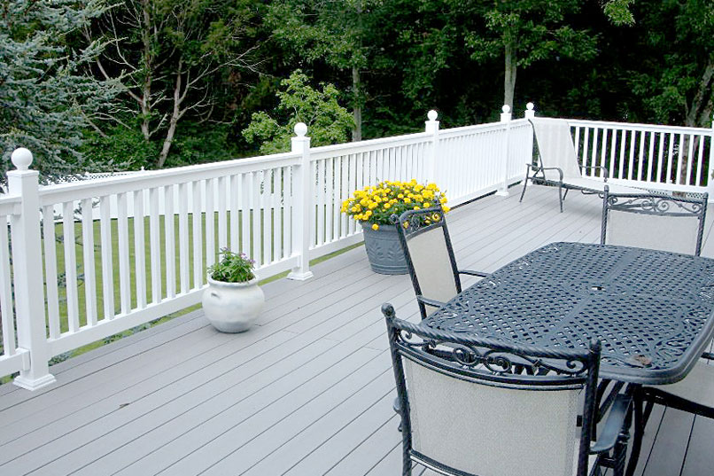 A deck with white fence