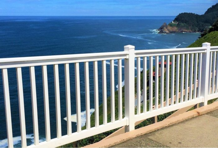 A white vinyl railing for a property near the ocean