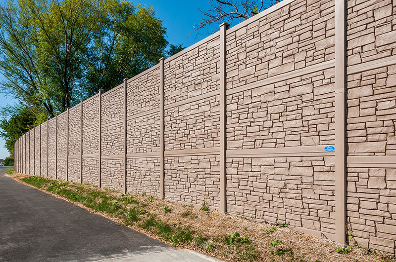 tall vinyl fence along a busy road