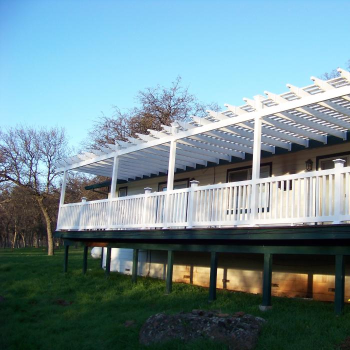 White vinyl pergola attached to a home’s deck