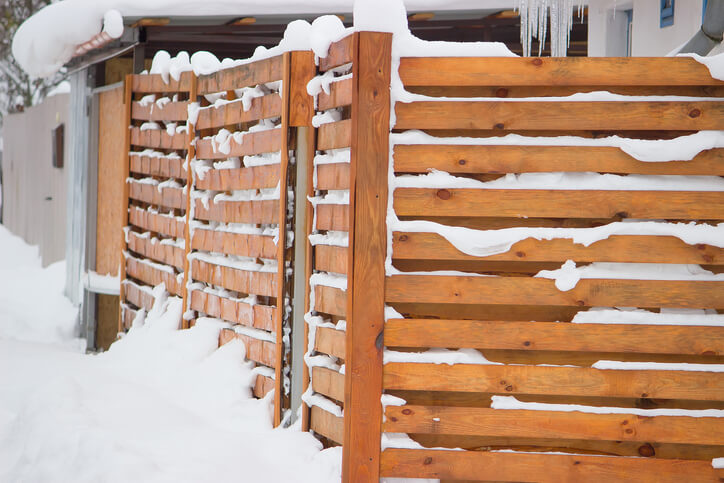 Snow covered wooden fence