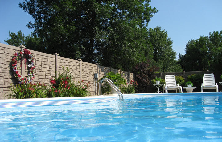 A SimTex EcoStone Simulated Stone fence installed around a private pool