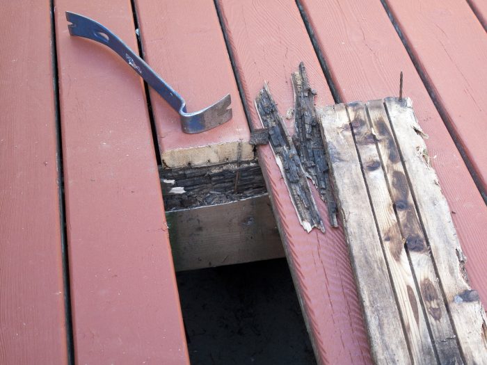 A wooden board pulled from a wooden deck because of rot