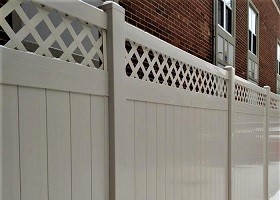 Tan privacy fence with lattice top